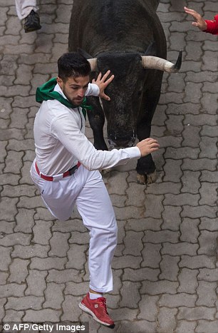 36187CBE00000578-3682545-The_best_known_running_of_the_bulls_is_held_each_year_in_Pamplon-a-140_1468102426165.jpg